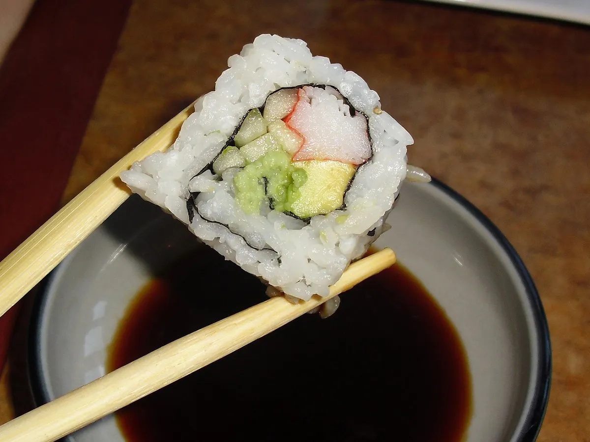 Shrimp tempura avocado sushi rolls drizzled with dark teriyaki sauce on clean white plate at NIGIRI BAR JAPANESE RESTAURANT, a Japanese Restaurant in Jacksonville